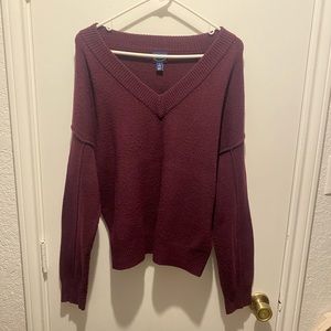 A Small Maroon pull-over sweater.